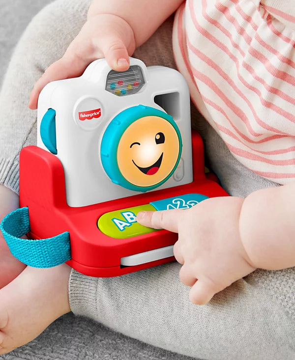 Child playing with a Fisher-Price toy camera