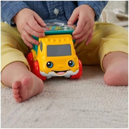 Child playing with a colorful toy bus 
