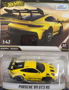 Hot Wheels Real Riders Porsche 911 GT3 RS die-cast toy car in its original blister packaging, featuring a bright yellow car with black accents on the front of the box.