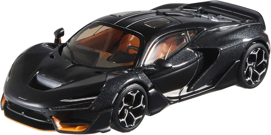 A black die-cast toy sports car with a textured metallic finish, orange interior, and black wheels, shown on a plain white background.