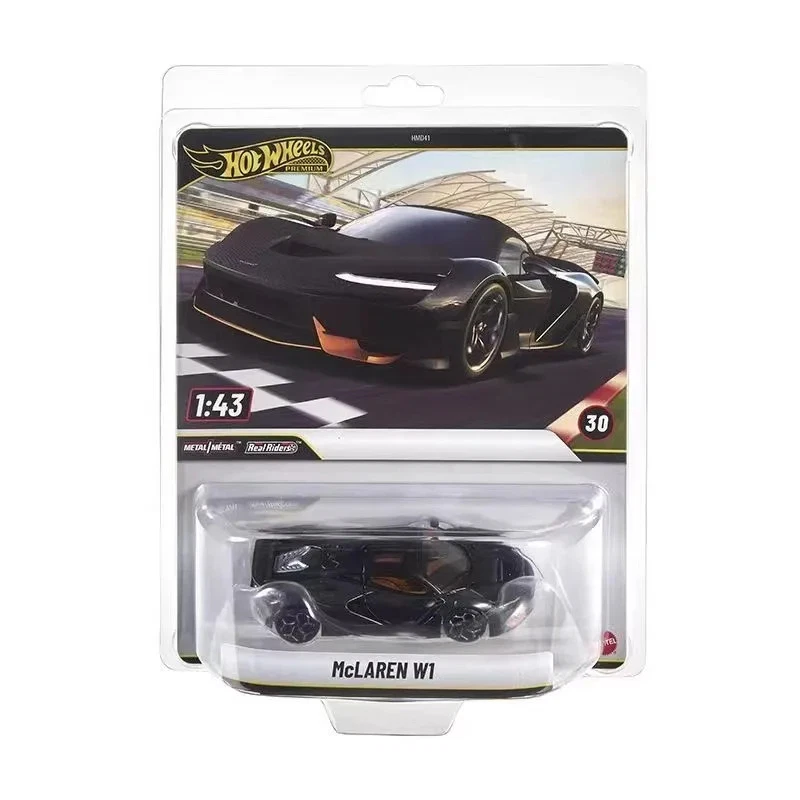Hot Wheels McLaren W1 1:43 scale die-cast toy car in its original blister card packaging, featuring a black car with orange accents on a white background.