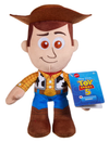 A Woody plush toy from Disney Pixar Toy Story 5, holding its original blue retail hangtag. The plush features Woody's classic brown hat, brown boots, yellow plaid shirt, and blue pants on a solid white background.
