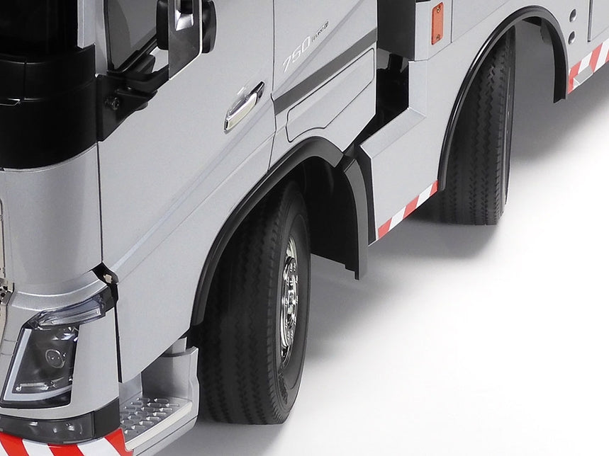 Close-up of a truck's front wheel and fender on a white background
