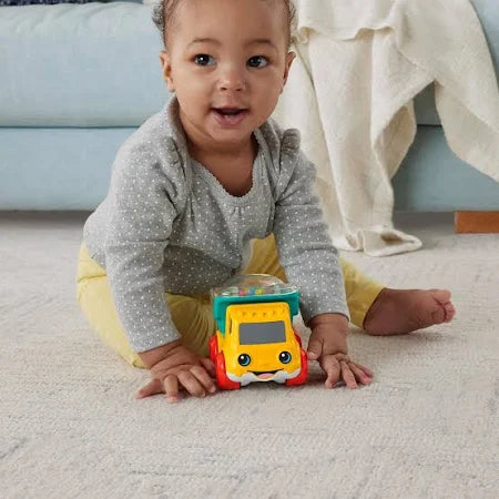 bright colors, a sweet smiling face, and a spinning front roller filled with colorful rattle beads